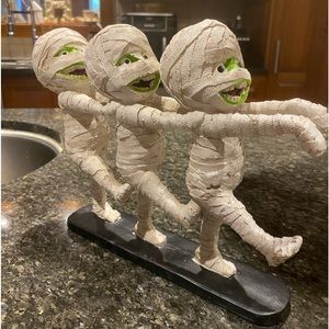 Three mummies on a board